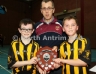 North Antrim Fixtures Secretary Alistair Mc Cambridge presenting McQuillans team captains Cathaoir Donnelly and Kane Bowden with the North Antrim U10 Division 1 Indoor Hurling League Shield